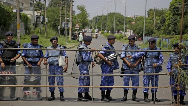 Anti-riot policemen stand guard on a barricaded road leading to a court in Panchkula, Haryana. Several north Indian cities in Punjab and Haryana have been under lockdown with mobile internet facilities halted in Punjab, Haryana and Chandigarh. Security cordons have also been placed around the court complex barring passage. Orders have been put out to convert stadiums where the Dera supporters converged into temporary jails as a response to any untoward incidents once the verdict is pronounced. (Altaf Qadri / AP)