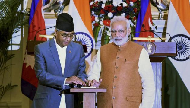 Prime Minister Narendra Modi and his Nepalese counterpart Sher Bahadur Deuba inaugurate an India-Nepal power transmission line, after talks at Hyderabad House in New Delhi on Thursday. (PTI Photo) Prime Minister Narendra Modi and his Nepalese counterpart Sher Bahadur Deuba inaugurate an India-Nepal power transmission line, after talks at Hyderabad House in New Delhi on Thursday. (PTI Photo)