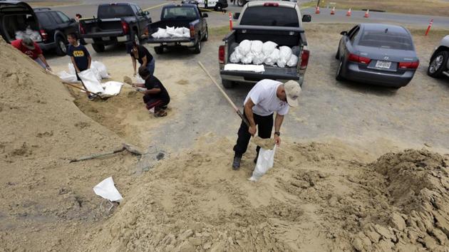 Martin Quintanilla fills sandbags as he and other residents prepare for Hurricane Harvey. Governor Greg Abbott has declared a state of disaster in 30 counties along the Gulf of Mexico. Abbott on Thursday activated 700 members of the Texas Army Guard, Texas Air National Guard and the Texas State Guard in as a precautionary measure. (Eric Gay / AP)