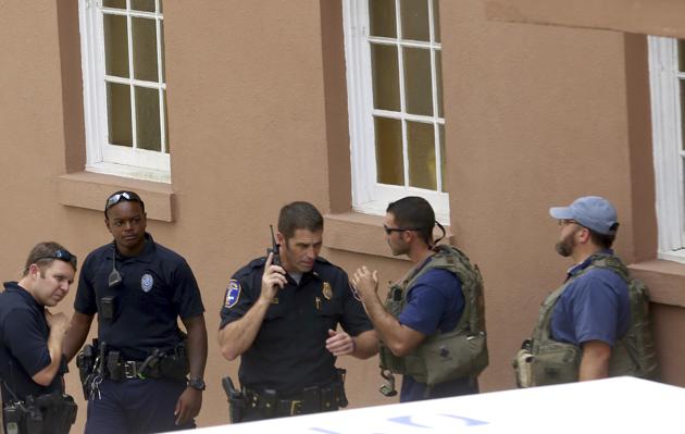 Police gather near the scene of a reported shooting in Charleston on Thursday. Authorities say a disgruntled employee shot one person and is holding hostages in a restaurant in an area that is popular with tourists. (AP Photo) Police gather near the scene of a reported shooting in Charleston on Thursday. Authorities say a disgruntled employee shot one person and is holding hostages in a restaurant in an area that is popular with tourists. (AP Photo)