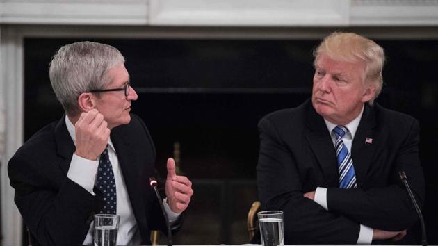 US President Donald Trump listens to Apple CEO Tim Cook speak during an American Technology Council roundtable at the White House in Washington, DC, on June 19, 2017. (AFP File Photo) US President Donald Trump listens to Apple CEO Tim Cook speak during an American Technology Council roundtable at the White House in Washington, DC, on June 19, 2017. (AFP File Photo)