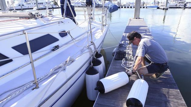 Ken Knox secures a friend's boat at the Corpus Christi Marina in preparation for Hurricane Harvey in Corpus Christi, Texas. The rise in sea level could be up to 12 feet, with waves as high as 20 feet above that. Rain is expected to range from 10 to 20 inches, and some areas could receive up to 30 inches of downpour. (Rachel Denny Clow / Corpus Christi Caller-Times via AP)