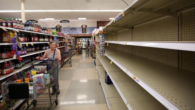 A shopper finds empty shelves on the bottled water section inside the Kroger store on in preparation of Hurricane Harvey in Houston. Civilians and emergency services have begun stockpiling essential supplies in anticipation of the hurricane. (Godofredo A. Vasquez / Houston Chronicle via AP)