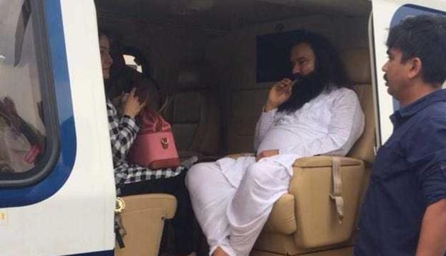 Dera Sacha Sauda chief Gurmeet Ram Rahim in a chopper on way to Rohtak on Friday.(HT Photo)