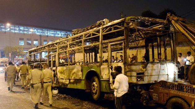 A DTC bus that was set on fire near Baadli metro station in New Delhi on Friday by followers of Dera Sacha Sauda chief Gurmeet Ram Rahim after he was convicted for rape.(PTI Photo)