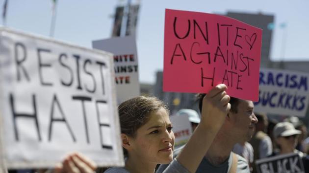 A woman holds up a sign at a rally in San Francisco, ahead of politically conservative rallies scheduled this weekend. Concerned about possible violence, city officials have urged residents to stay away from other gatherings on Saturday and Sunday. (AP Photo) A woman holds up a sign at a rally in San Francisco, ahead of politically conservative rallies scheduled this weekend. Concerned about possible violence, city officials have urged residents to stay away from other gatherings on Saturday and Sunday. (AP Photo)