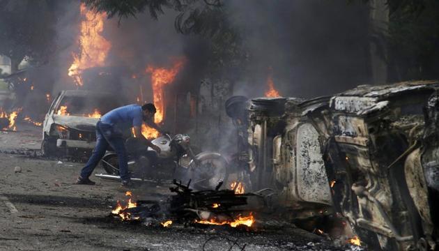 A man lifts a motorbike in a vandalised area by Dera Sacha Sauda sect members in Panchkula. (AP Photo) A man lifts a motorbike in a vandalised area by Dera Sacha Sauda sect members in Panchkula. (AP Photo)