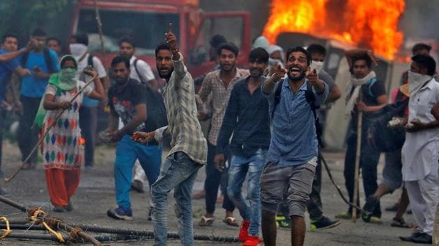 Supporters of Gurmeet Ram Rahim’s Dera Sacha Sauda react during the violence in Panchkula, on August 25, 2017.(Reuters Photo) Supporters of Gurmeet Ram Rahim’s Dera Sacha Sauda react during the violence in Panchkula, on August 25, 2017.(Reuters Photo)