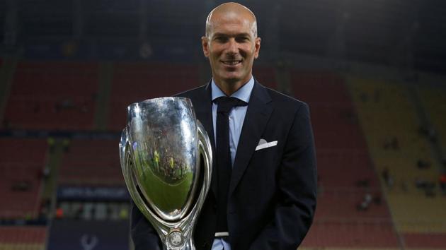 Real Madrid manager Zinedine Zidane poses with the UEFA Super Cup trophy. (REUTERS) Real Madrid manager Zinedine Zidane poses with the UEFA Super Cup trophy. (REUTERS)