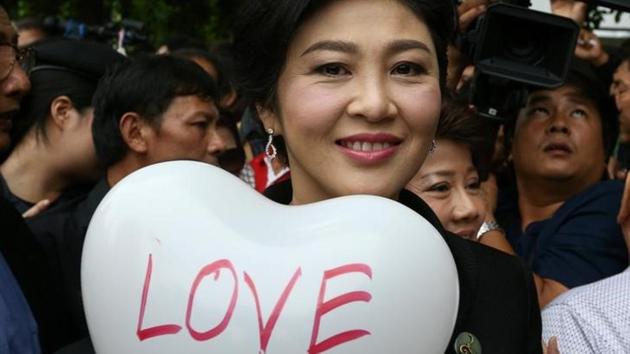 Ousted former Thai prime minister Yingluck Shinawatra holds a balloon as she arrives at the Supreme Court in Bangkok on July 21, 2017. (Reuters) Ousted former Thai prime minister Yingluck Shinawatra holds a balloon as she arrives at the Supreme Court in Bangkok on July 21, 2017. (Reuters)