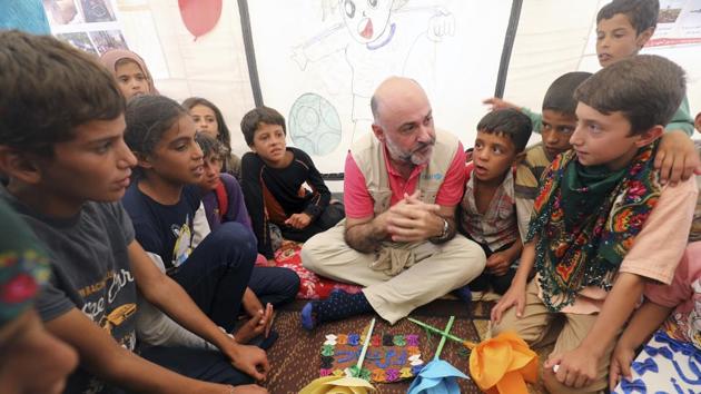 This Thursday, Aug 24, 2017 photo provided by UNICEF, shows Fran Equiza, center, the UNICEF representative to Syria, speaking with Syrian children at Mabrouka camp in Ein Issa, northern Syria. (AP) This Thursday, Aug 24, 2017 photo provided by UNICEF, shows Fran Equiza, center, the UNICEF representative to Syria, speaking with Syrian children at Mabrouka camp in Ein Issa, northern Syria. (AP)