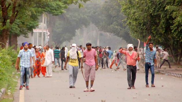 Supporters of Dera Sacha Sauda chief Gurmeet Ram Rahim pelt stones after a court verdict convicted the sect leader in a rape case, in Panchkula on Friday. (PTI) Supporters of Dera Sacha Sauda chief Gurmeet Ram Rahim pelt stones after a court verdict convicted the sect leader in a rape case, in Panchkula on Friday. (PTI)