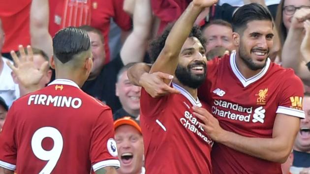 Liverpool's Mohamed Salah (C) celebrates with teammates after scoring their third goal against Arsenal. (AFP) Liverpool's Mohamed Salah (C) celebrates with teammates after scoring their third goal against Arsenal. (AFP)