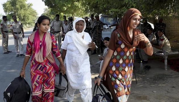 Ram Rahim’s followers leave his dera in Sirsa on Sunday. Around 150 women have been booked for the violence in Panchkula. (PTI) Ram Rahim’s followers leave his dera in Sirsa on Sunday. Around 150 women have been booked for the violence in Panchkula. (PTI)