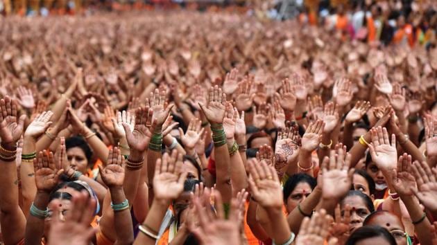 Women raise their hands during a prayer at Dagdusheth Halwai in Pune on Saturday. (Pratham Gokhale/HT PHOTO)