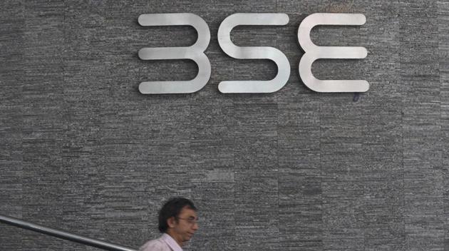 An officegoer walks past the Bombay Stock Exchange (BSE) logo at the BSE building in Mumbai on July 25, 2017. (AFP) An officegoer walks past the Bombay Stock Exchange (BSE) logo at the BSE building in Mumbai on July 25, 2017. (AFP)