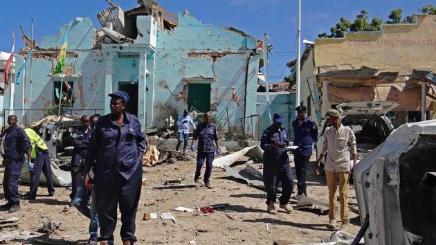 People walk on the scene of a car bomb attack in Mogadishu, in the southern district of Wadajir on June 20, 2017. At least 10 people were killed and a senior government official injured when Shabaab Islamists drove an explosives-laden minibus through a security barrier outside local government offices. The attack was claimed by Al-Qaeda linked Shabaab militants in a statement issued by them. (AFP) People walk on the scene of a car bomb attack in Mogadishu, in the southern district of Wadajir on June 20, 2017. At least 10 people were killed and a senior government official injured when Shabaab Islamists drove an explosives-laden minibus through a security barrier outside local government offices. The attack was claimed by Al-Qaeda linked Shabaab militants in a statement issued by them. (AFP)