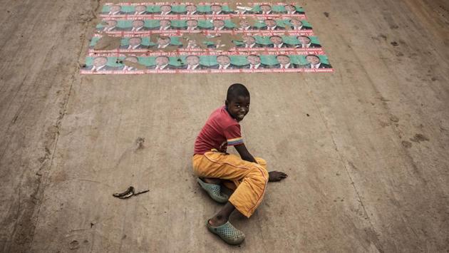 Electoral posters for Isaías Samakuva, the presidential candidate for the National Union for the Total Independence of Angola (UNITA) are sen plastered on the containment walls of a train track in the Viana district in Luanda, on August 22, 2017 as a boy slides down. (Marco Longari/ AFP) Electoral posters for Isaías Samakuva, the presidential candidate for the National Union for the Total Independence of Angola (UNITA) are sen plastered on the containment walls of a train track in the Viana district in Luanda, on August 22, 2017 as a boy slides down. (Marco Longari/ AFP)