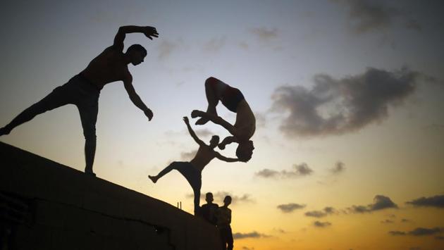 Palestinian youths practice parkour by the beach at dusk in Gaza City on August 25. (Mohammed Abed/ AFP) Palestinian youths practice parkour by the beach at dusk in Gaza City on August 25. (Mohammed Abed/ AFP)