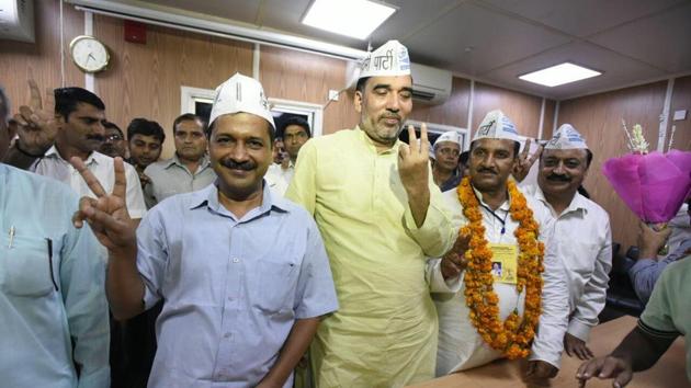 Delhi CM Arvind Kejriwal and rural development minister Gopal Rai with AAP candidate Ram Chandra after the party’s victory in Bawana bypoll on Monday.(Sonu Metha / HT Photo)