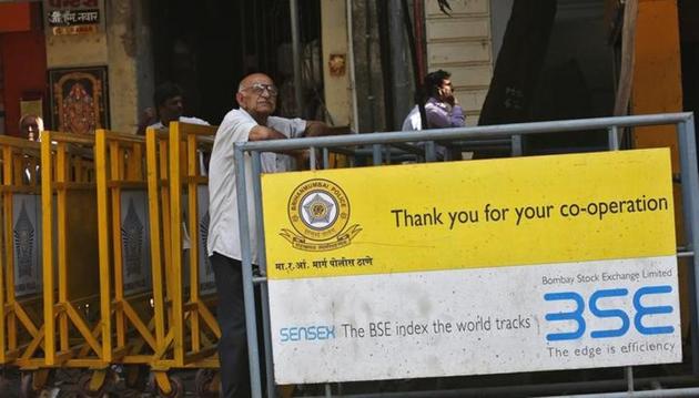 A man looks at a screen across the road displaying the Sensex on the facade of the Bombay Stock Exchange (BSE) building in Mumbai. (Reuters File) A man looks at a screen across the road displaying the Sensex on the facade of the Bombay Stock Exchange (BSE) building in Mumbai. (Reuters File)