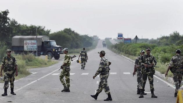 Haryana and Punjab brace anticipatorily with the deployment of thousands of riot police, setting up a five-tier cordon around Rohtak jail, shutting mobile internet services, schools and colleges. CBI judge Jagdeep Singh sentenced ‘godman’ Gurmeet Ram Rahim Singh to 20 years in jail. The Dera chief’s followers went on rampage after he was convicted of rape on Friday. Rohtak district has been cordoned off by paramilitary forces and Haryana Police with the army on standby. (Kamal Singh / PTI)