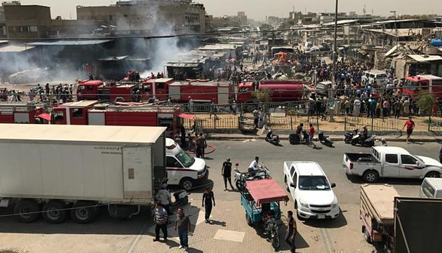 People and security forces gather at the scene of a car bomb explosion in the wholesale Jamila market in Baghdad's Shiite district of Sadr City, Iraq. (AP) People and security forces gather at the scene of a car bomb explosion in the wholesale Jamila market in Baghdad's Shiite district of Sadr City, Iraq. (AP)