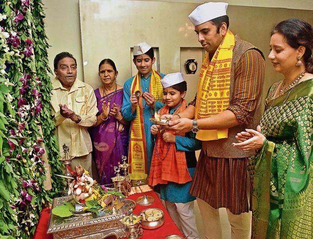 Saurabh Gadgil (second from right) along with his wife, sons and parents, celebrates the Ganesh festival at home. The Gadgils have been bringing Bappa home for a day-and-a-half since 1958.(Pratham Gokhale/HT PHOTO)