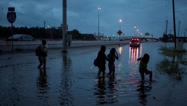 Members of a family walk through flood waters from hurricane Harvey on the feeder road of Interstate 45 in Houston, Texas. (REUTERS) Members of a family walk through flood waters from hurricane Harvey on the feeder road of Interstate 45 in Houston, Texas. (REUTERS)
