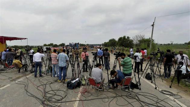 Media persons near Sunariya Jail prepare for the coverage of announcement of Dera Sacha Sauda Chief Ram Rahim's sentence, in Rohtak. No gathering of dera supporters in Rohtak, says Mohd Akil, AGDP (law and order) in contrast to the August 25 reactions towards media persons following the announcement of the guilt verdict. (Kamal SIngh / PTI)