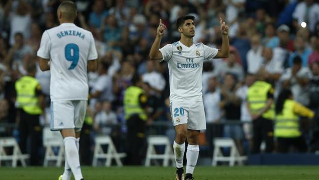 Real Madrid's Marco Asensio (R) celebrates after scoring his side's second goal against Valencia.(AP)