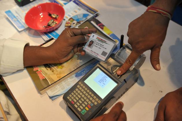 This file photo shows a visitor giving a thumb impression to withdraw money from his bank account with his Aadhaar or Unique Identification (UID) card during a Digi Dhan Mela, held to promote digital payment, in Hyderabad.