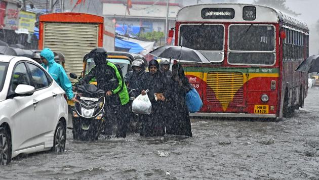 People walk through a flooded road at Andheri in Mumbai on Tuesday, August 29, 2017. (HT Photo / Shashi S Kashyap)