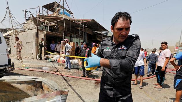 A member of Iraqi security forces put a warning tape at the site of a car bomb attack in Jamila market in Baghdad.IS has claimed several bombings in Baghdad, many taking place after the jihadist group became the target of a massive assault on its Mosul bastion which Iraqi forces retook in July after nine months of fighting. (Wissm al-Okili / REUTERS)