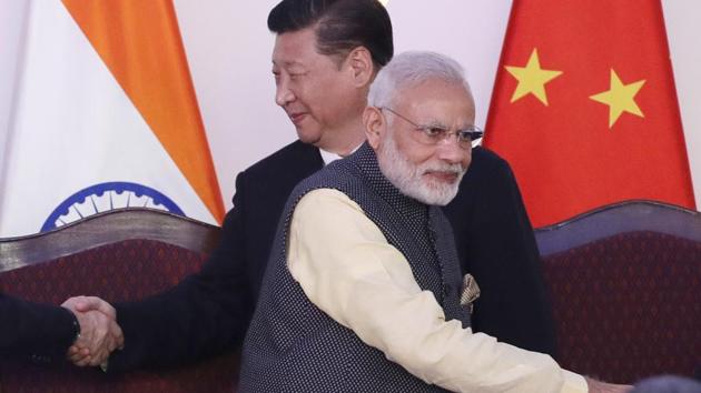 File photo of Prime Minister Narendra Modi with Chinese President Xi Jinping at the BRICS summit in Goa in October last year.(AP)