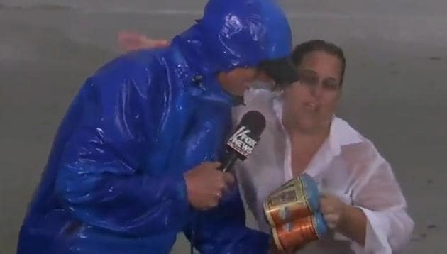 A woman hands a news reporter beer cans on live television. (Fox 4 News/Twitter) A woman hands a news reporter beer cans on live television. (Fox 4 News/Twitter)
