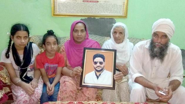Family members of Mukhjit Singh Mukha, a local leader of the SAD, who was shot dead by a police team on June 16, 2015. (HT Photo) Family members of Mukhjit Singh Mukha, a local leader of the SAD, who was shot dead by a police team on June 16, 2015. (HT Photo)