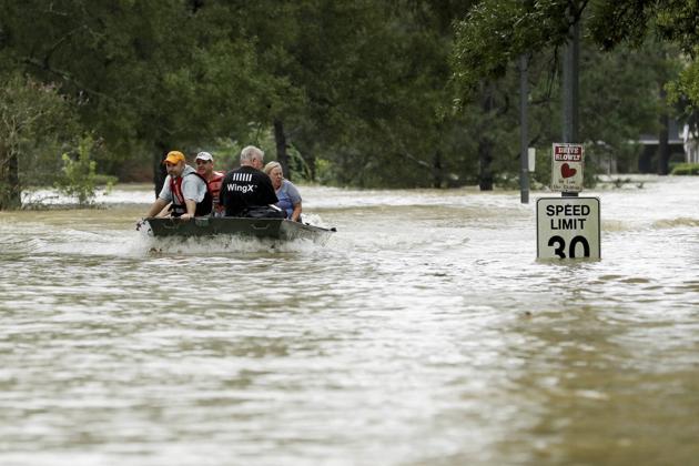 People are evacuated by boat as floodwaters from Tropical Storm Harvey rise, in Kingwood, Texas, on Tuesday. (AP) People are evacuated by boat as floodwaters from Tropical Storm Harvey rise, in Kingwood, Texas, on Tuesday. (AP)