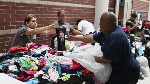 Volunteers sort through donated clothing items at a shelter which will be distributed to families displaced after their neighbourhoods were inundated with rain water following Hurricane Harvey on August 29, 2017 in Channelview, Texas. (AFP) Volunteers sort through donated clothing items at a shelter which will be distributed to families displaced after their neighbourhoods were inundated with rain water following Hurricane Harvey on August 29, 2017 in Channelview, Texas. (AFP)