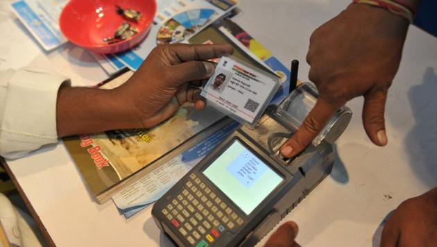 A man gives a thumb impression to withdraw money from his bank account with his Aadhaar in Hyderabad. (AFP File Photo) A man gives a thumb impression to withdraw money from his bank account with his Aadhaar in Hyderabad. (AFP File Photo)