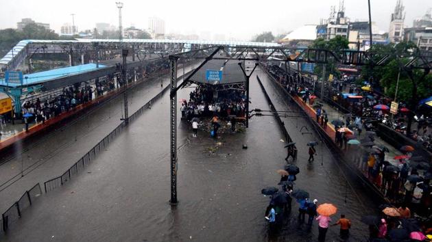 Thane railway station is completely flooded bringing central Railway trains to a halt after heavy rains lashed Thane in Mumbai on Tuesday. (PTI Photo) Thane railway station is completely flooded bringing central Railway trains to a halt after heavy rains lashed Thane in Mumbai on Tuesday. (PTI Photo)