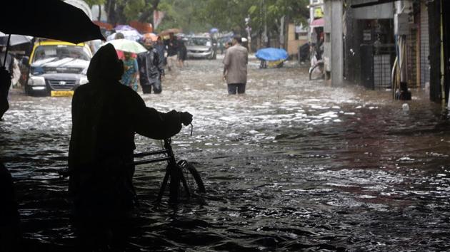 People move through a waterlogged street following heavy rains in Mumbai, India, Tuesday, Aug. 29, 2017. Heavy rains Tuesday brought Mumbai to a halt flooding vast areas of the city. (AP Photo) People move through a waterlogged street following heavy rains in Mumbai, India, Tuesday, Aug. 29, 2017. Heavy rains Tuesday brought Mumbai to a halt flooding vast areas of the city. (AP Photo)