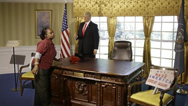 Shameka Nurse, a guest host at the Dreamland Wax Museum, works tending to the Donald Trump wax figure standing in an Oval Office scene at the museum. (AP) Shameka Nurse, a guest host at the Dreamland Wax Museum, works tending to the Donald Trump wax figure standing in an Oval Office scene at the museum. (AP)