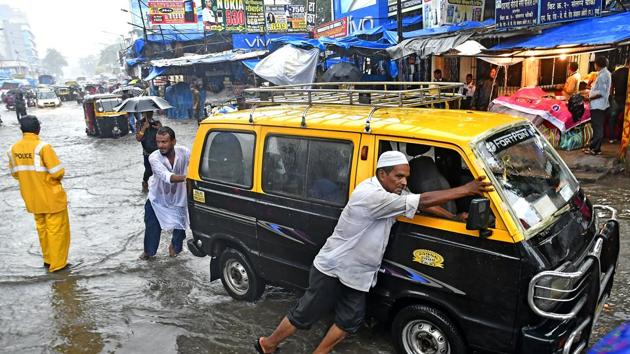 People tow a van through a flooded road in Andheri in Mumbai, India. , on Tuesday, August 29, 2017. (Shashi S Kashyap/ HT PHOTO) People tow a van through a flooded road in Andheri in Mumbai, India. , on Tuesday, August 29, 2017. (Shashi S Kashyap/ HT PHOTO)