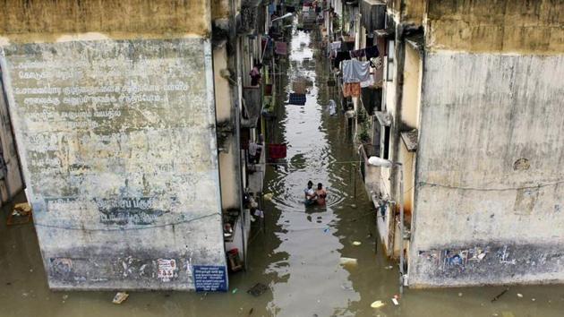 People gather around a residential area that was flooded after heavy rains in Chennai on November 18, 2015.(AFP File Photo)