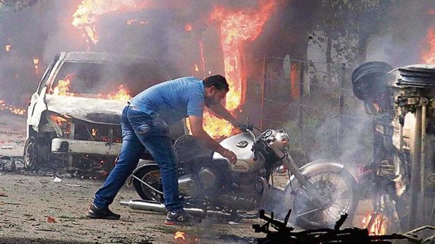A many as 34 people were killed and 250 injured as the Dera Sacha Sauda followers indulged in violence and clashed with the security forces in Panchkula on August 25 after the special CBI court convicted the sect head Gurmeet Ram Rahim in a rape case. (AP Photo) A many as 34 people were killed and 250 injured as the Dera Sacha Sauda followers indulged in violence and clashed with the security forces in Panchkula on August 25 after the special CBI court convicted the sect head Gurmeet Ram Rahim in a rape case. (AP Photo)