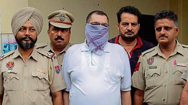 The fake IPS officer in police custody in Amritsar on Wednesday. (Sameer Sehgal/HT) The fake IPS officer in police custody in Amritsar on Wednesday. (Sameer Sehgal/HT)