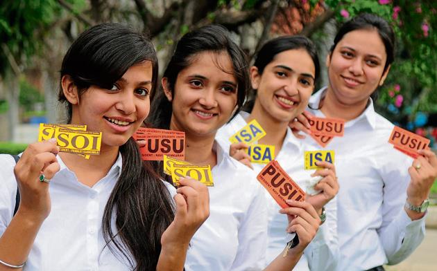 Girls showing stickers of various in Panjab University in Chandigarh on Thursday.(Anil Dayal/HT)