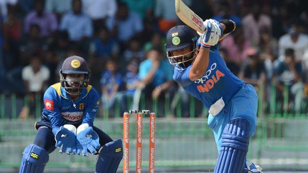 Indian cricket captain Virat Kohli (R) in action during the fourth one day international (ODI) match against Sri Lanka.(AFP)