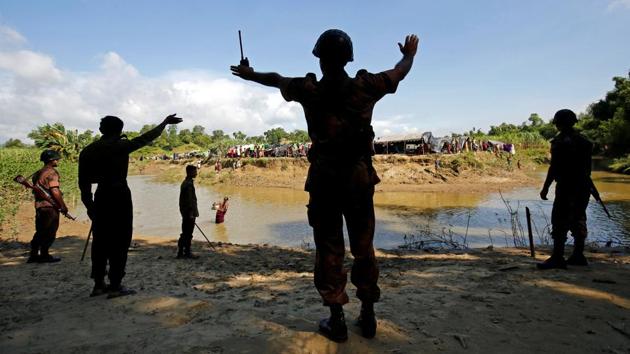 Members of Border Guard Bangladesh (BGB) command the Rohingya people taking shelter in No Man’s Land between Bangladesh-Myanmar border to not cross the canal into Cox’s Bazar, Bangladesh. Bangladesh’s border guards turned back 171 Rohingya after detaining them at different border points over the last two days, said Col. S.M. Ariful islam, a director of the Border Guard Bangladesh. (Mohammad Ponir Hossain/ REUTERS) Members of Border Guard Bangladesh (BGB) command the Rohingya people taking shelter in No Man’s Land between Bangladesh-Myanmar border to not cross the canal into Cox’s Bazar, Bangladesh. Bangladesh’s border guards turned back 171 Rohingya after detaining them at different border points over the last two days, said Col. S.M. Ariful islam, a director of the Border Guard Bangladesh. (Mohammad Ponir Hossain/ REUTERS)